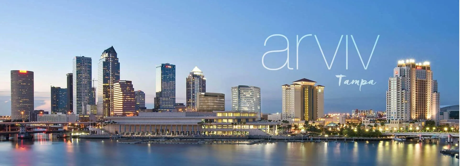 The downtown Tampa skyline at dusk, carrying the Arviv Medical Aesthetics Tampa wordmark