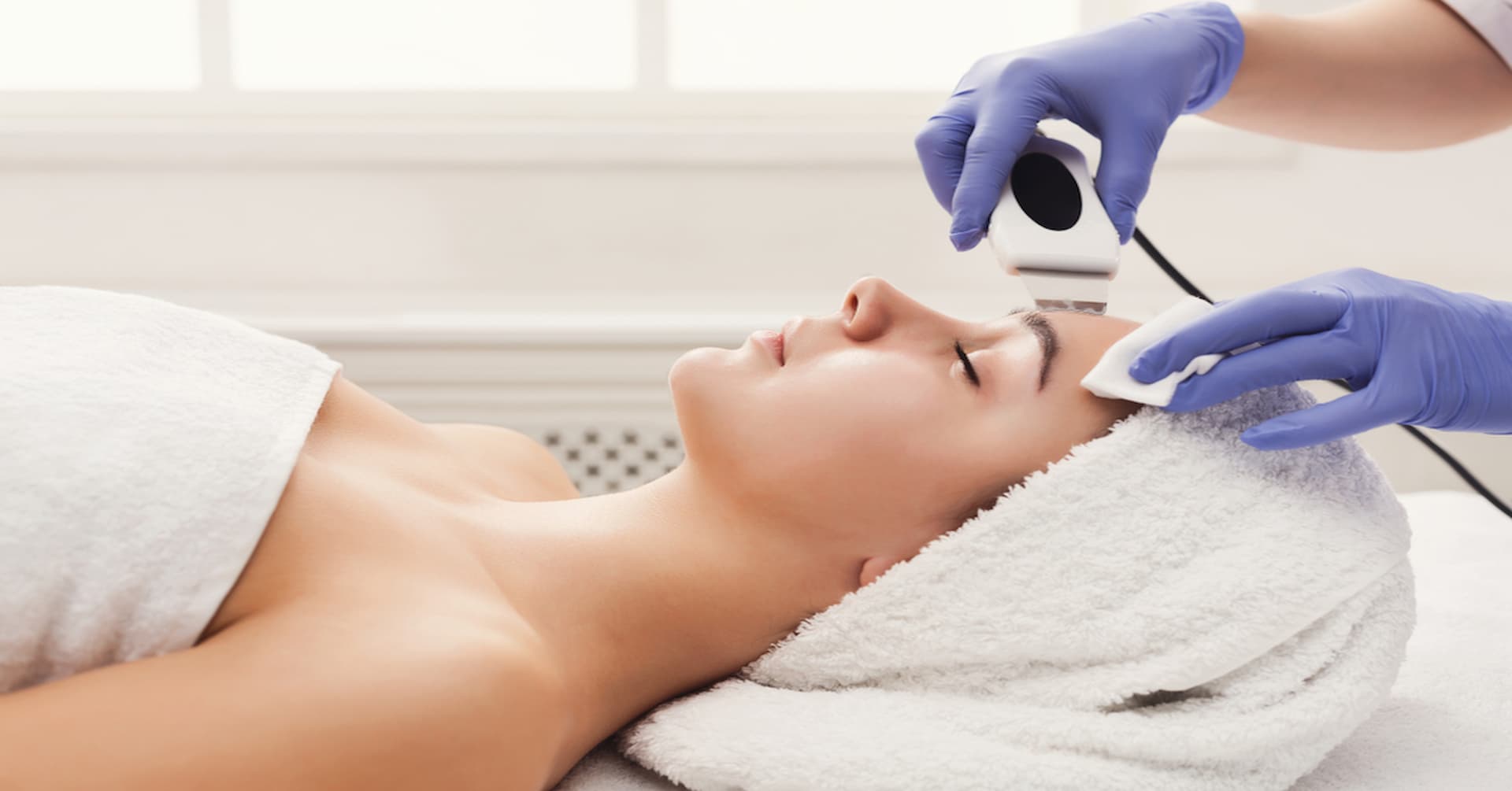 A woman receives a skin treatment from a professional at Arviv Medical Aesthetics Ocala, Florida location